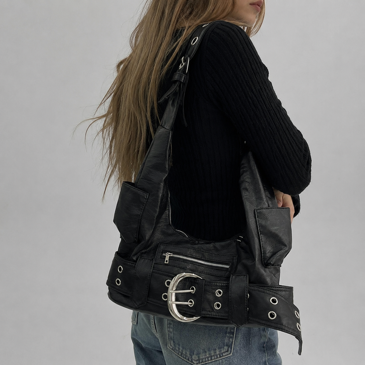 Model carrying a black shoulder bag
