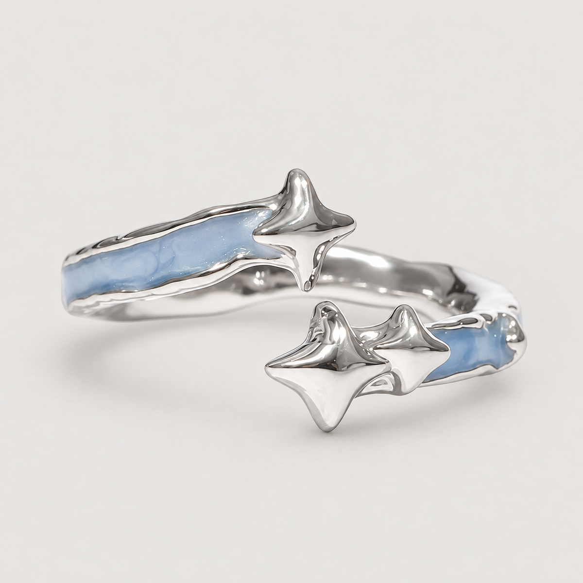Blue star open ring on an ivory grey background