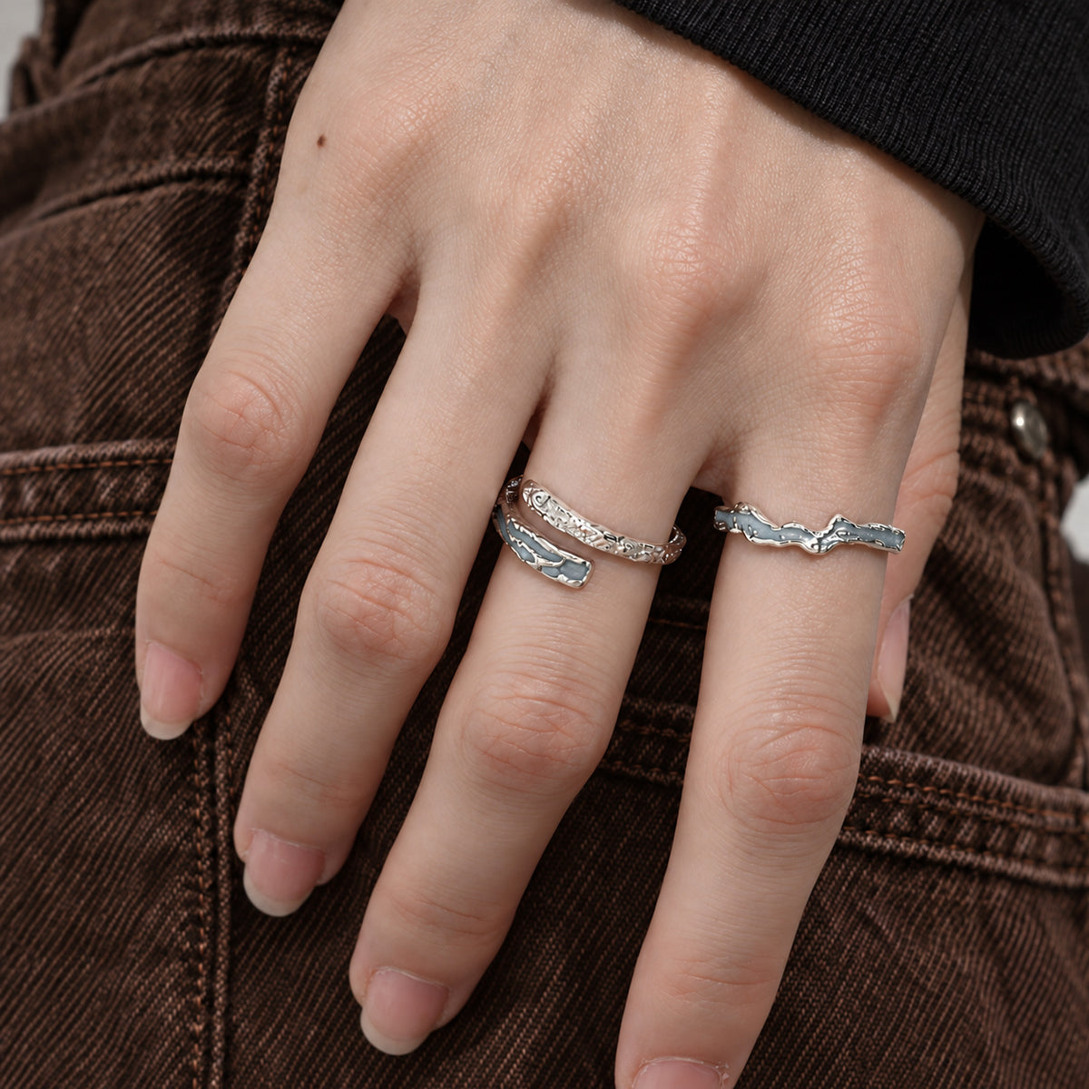 Blue bypass and wave rings worn on hand