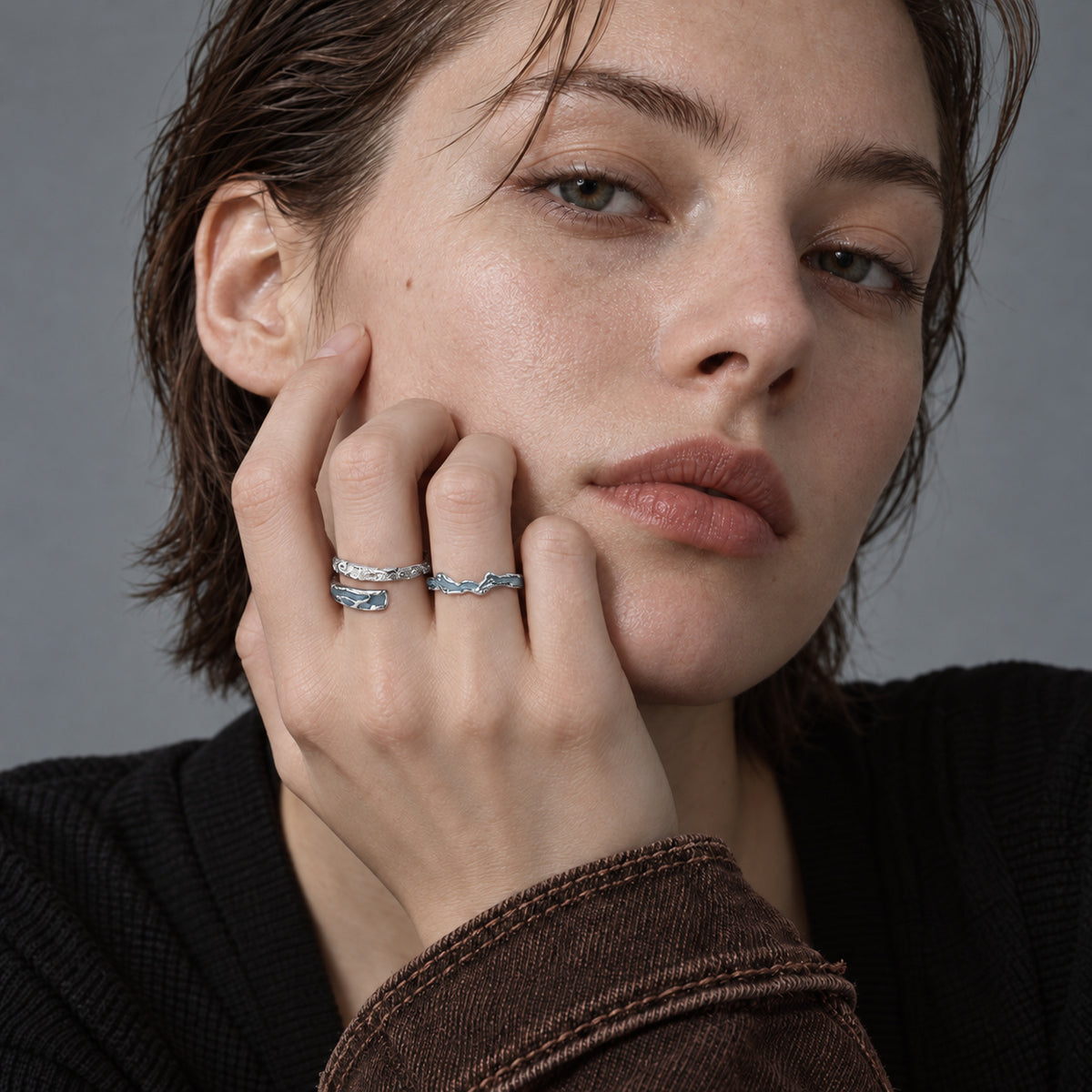 Model wearing blue bypass and wave rings
