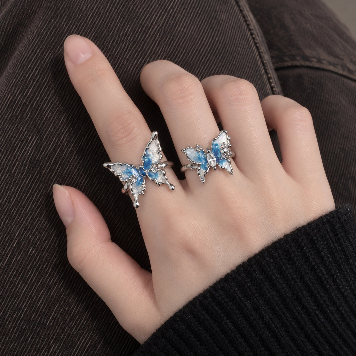 Blue butterfly rings worn on hand