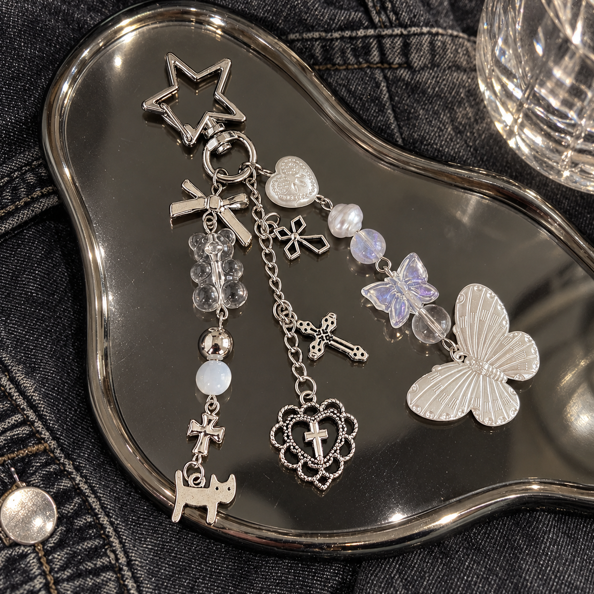 Butterfly charm keychain on a silver tray