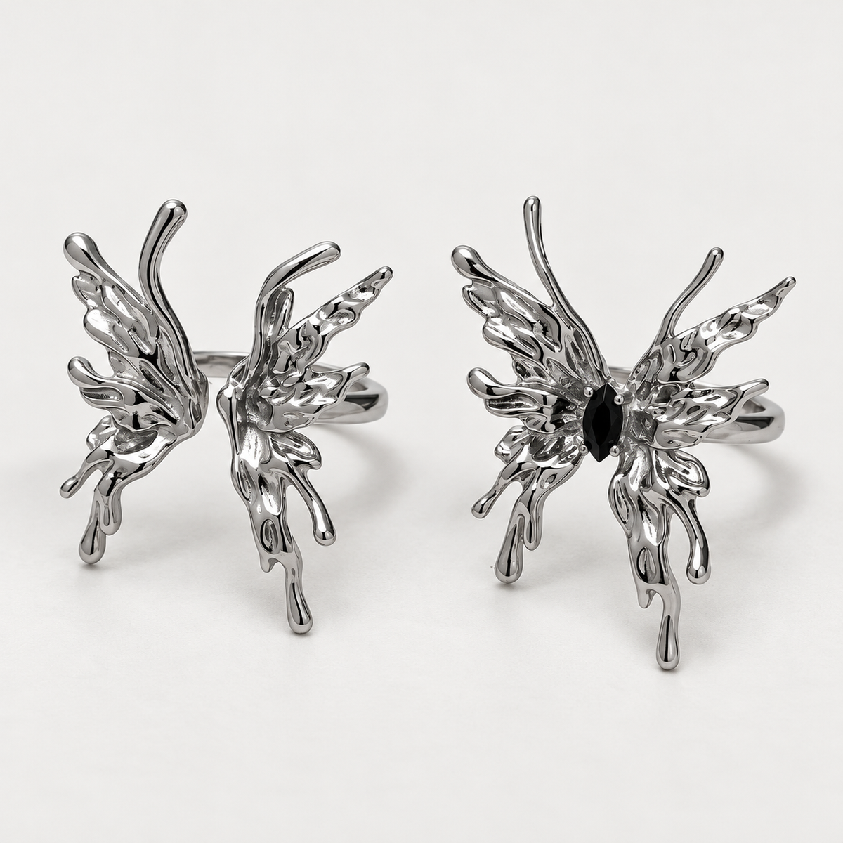Open-centre and black-stone flame butterfly rings, sold individually