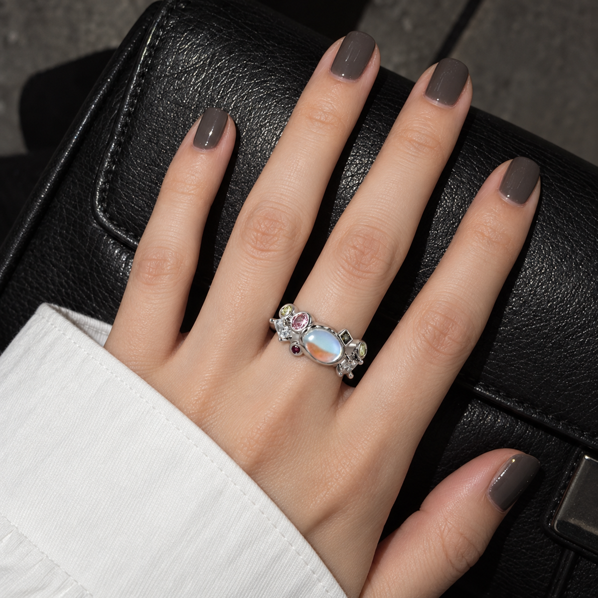 Iridescent cluster ring worn on hand