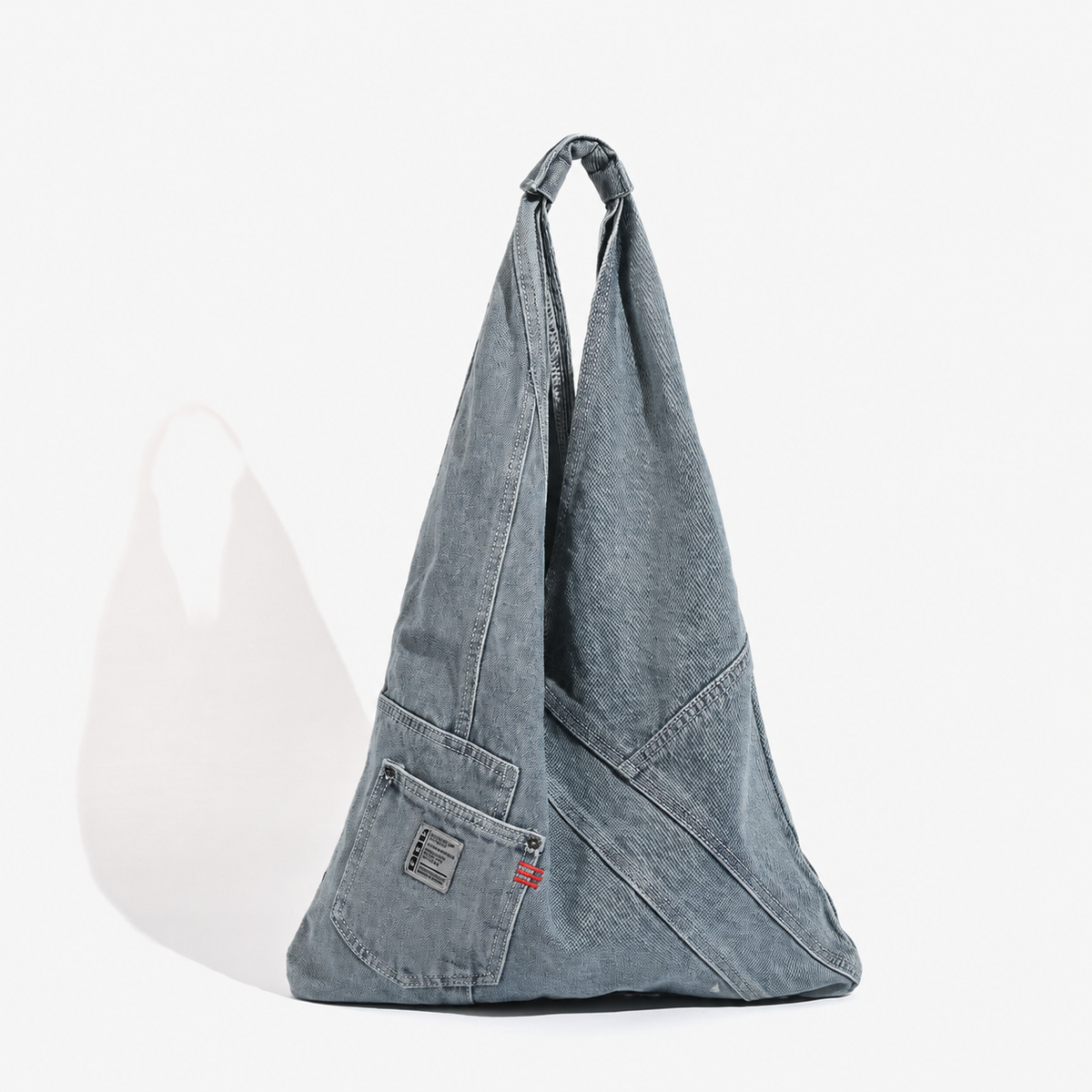 Denim triangle shoulder bag — light blue front