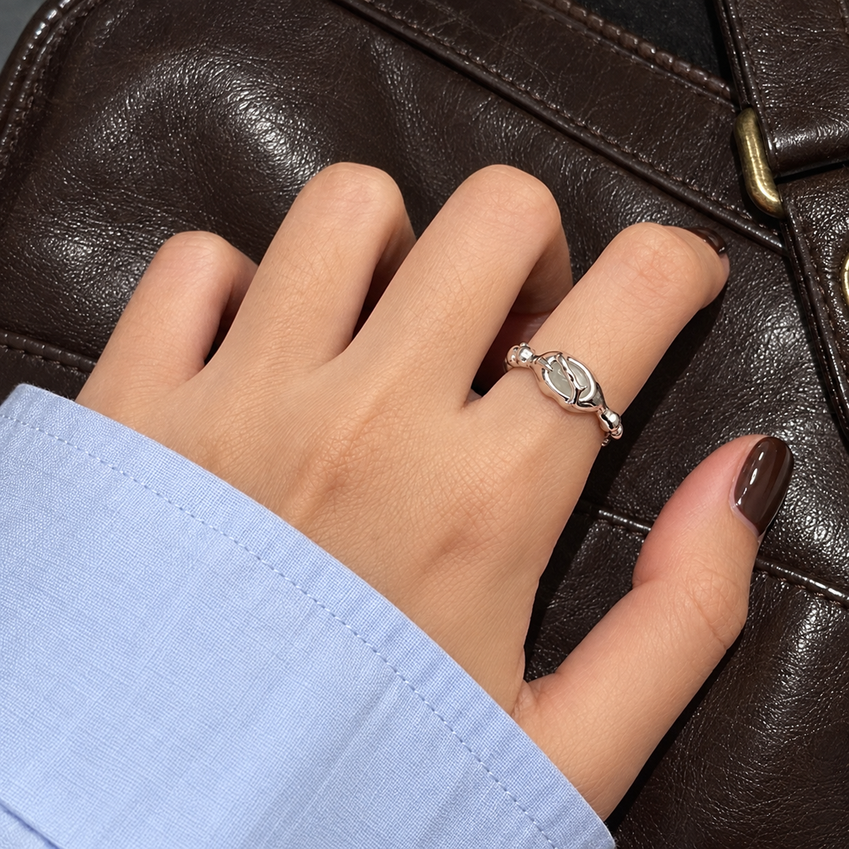 Organic wrapped stone ring worn on hand