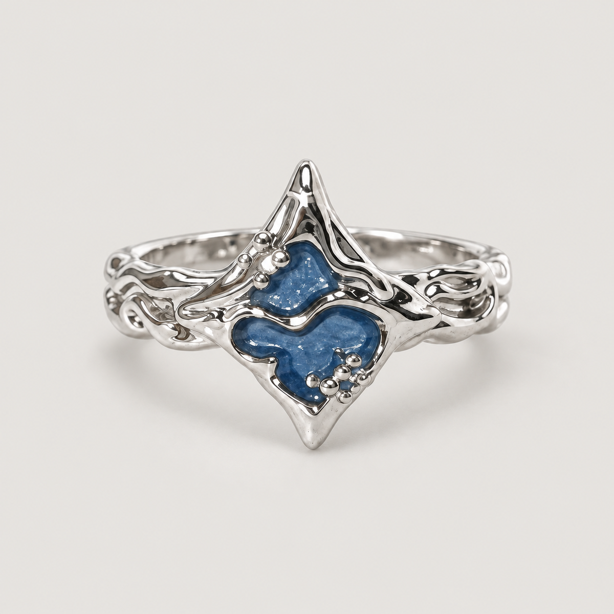 Blue Pointed Ring on a warm grey background