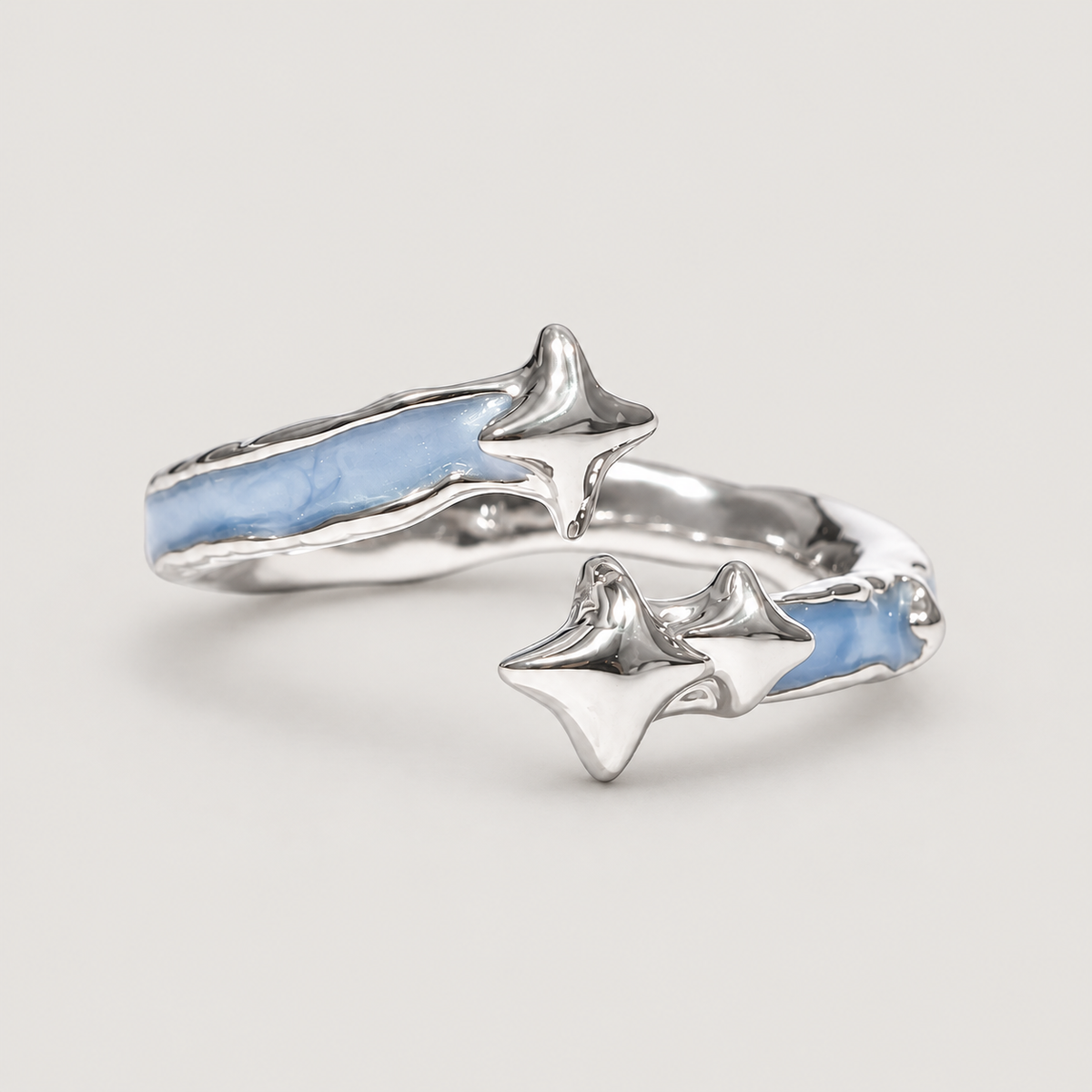 Blue Star Open Ring on a warm grey background