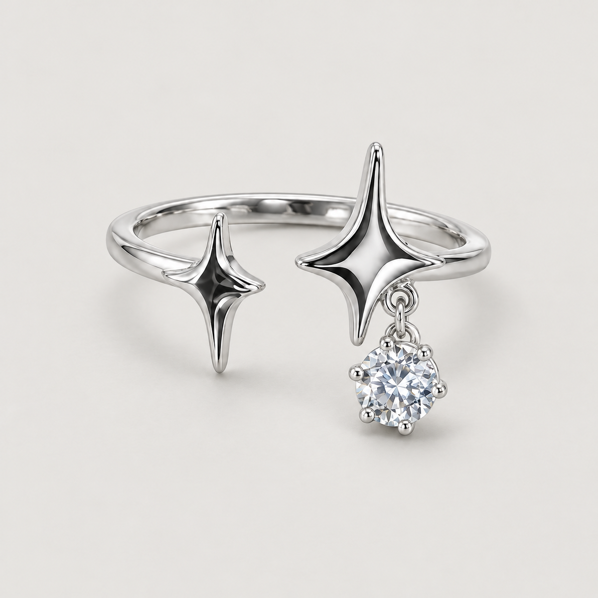 Double Star Drop Ring on a warm grey background