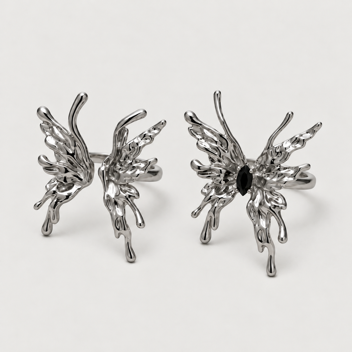 Flame Butterfly Ring on a warm grey background