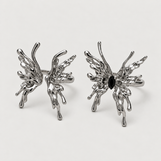 Flame Butterfly Ring on a warm grey background