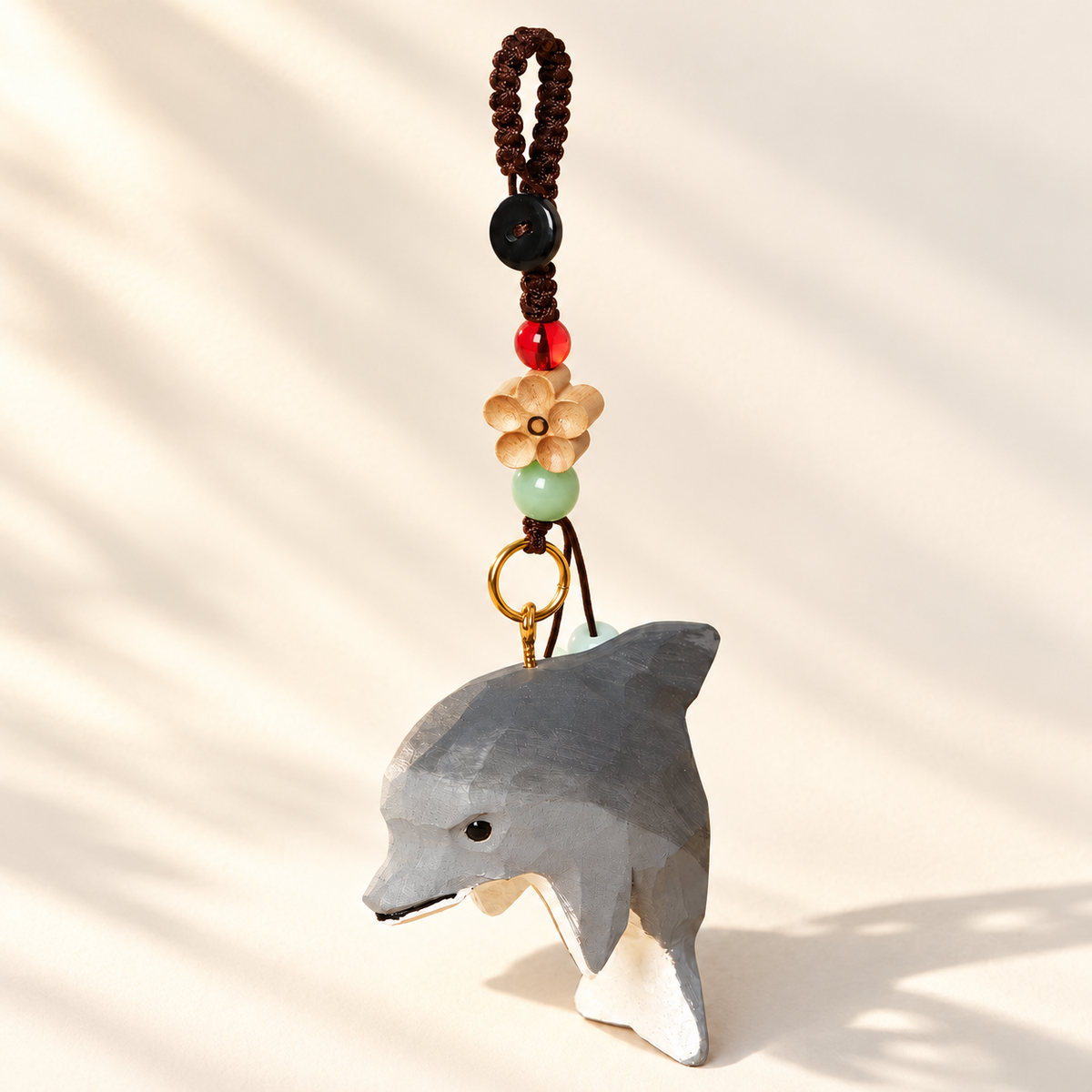 Dolphin wooden charm on ivory background